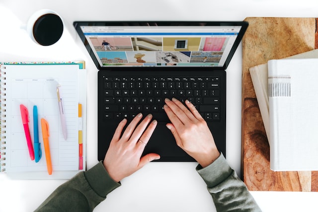 Overhead shot of someone using thier laptop to work on their marketing strategy